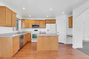 Open kitchen with island and hard floors