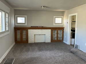 Unfurnished living room featuring carpet