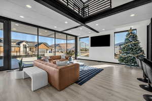 Living room with light wood-type flooring and a wealth of natural light