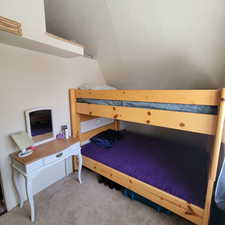 Carpeted bedroom with vaulted ceiling