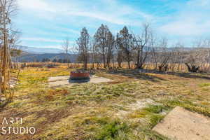 View of yard with a mountain view and a rural view