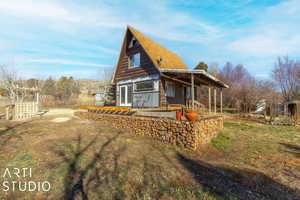 Back of house featuring a lawn