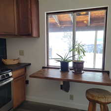 Kitchen with stainless steel electric range oven and a wealth of natural light