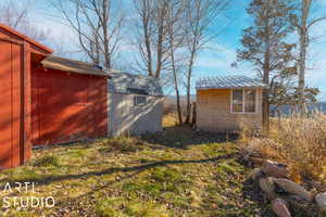 View of yard with a storage unit