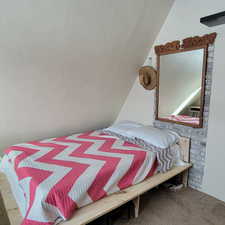 Bedroom with carpet and lofted ceiling