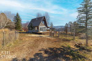 View of side of home with a mountain view