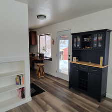 Interior space featuring dark hardwood / wood-style floors, built in features, and a textured ceiling