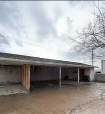 View of parking / parking lot, and storage closets