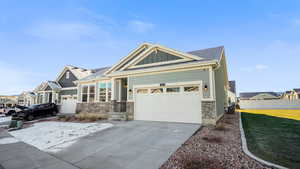 View of front of house featuring central AC, a front yard, and a garage