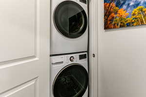 Laundry area with stacked washing maching and dryer