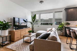 Living room featuring light hardwood / wood-style flooring and a textured ceiling