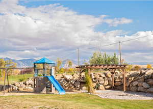 View of playground with a mountain view