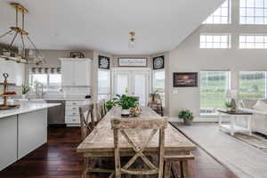 Dining area featuring french doors, dark wood-type flooring, and sink