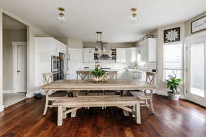 Dining area with dark hardwood / wood-style floors