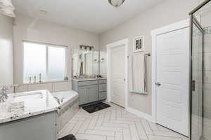 Bathroom featuring vanity and plus walk in shower