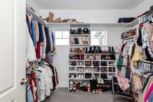 Spacious closet featuring carpet flooring