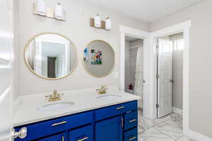 Bathroom with vanity and curtained shower