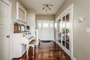 Entryway with dark hardwood / wood-style floors