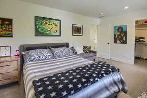 Bedroom featuring carpet flooring, a walk in closet, and a closet