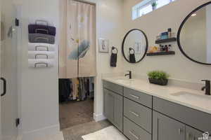 Bathroom featuring tile floor and double sink