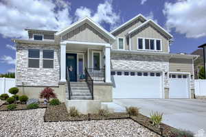 Craftsman inspired custom home featuring a 3 car garage