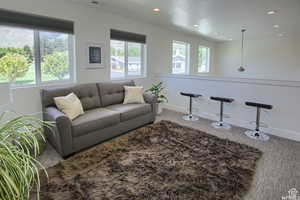 Carpeted Loft/living room featuring a healthy amount of sunlight