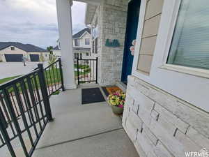 View of exterior entry with covered porch