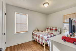 Bedroom featuring a textured ceiling and hardwood / wood-style flooring