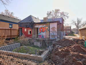 Rear view of property with central AC