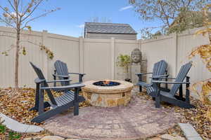 View of patio with an outdoor fire pit