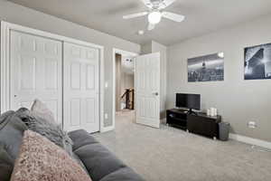 Living room with light carpet and ceiling fan