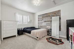 Bedroom featuring light carpet