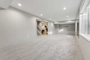 Basement with light colored carpet