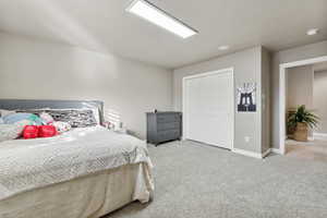 Bedroom featuring light carpet