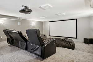 Home theater with carpet and a textured ceiling