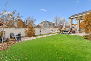 View of yard with a patio, a fire pit, and ceiling fan