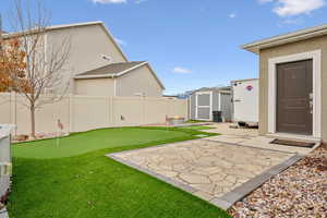 View of yard featuring a patio and a shed