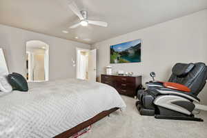 Carpeted bedroom with ceiling fan