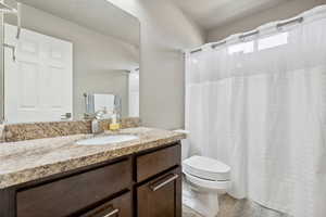 Bathroom with tile patterned flooring, vanity, and toilet