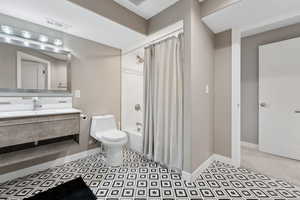 Full bathroom featuring shower / tub combo, vanity, and toilet