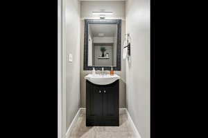 Bathroom featuring tile patterned flooring and vanity