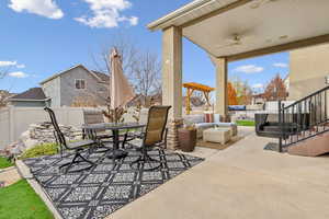 View of patio / terrace featuring ceiling fan, a hot tub, and an outdoor living space