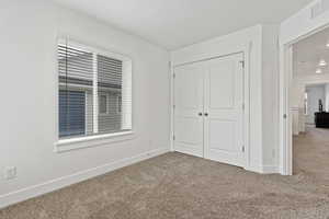 Unfurnished bedroom featuring carpet floors and a closet