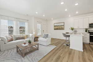 Living room featuring sink and light wood-type flooring