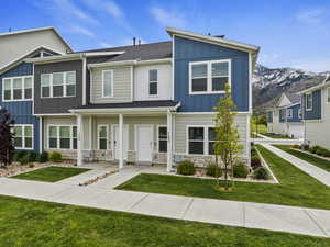 View of front of house with a mountain view and a front yard