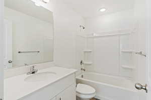 Full bathroom featuring vanity,  shower combination, and toilet