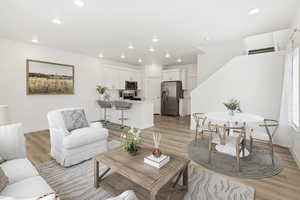 Living room with light hardwood / wood-style floors