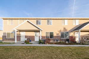 View of front of home featuring central air condition unit and a front lawn