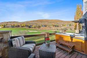 Deck featuring a mountain view and a hot tub