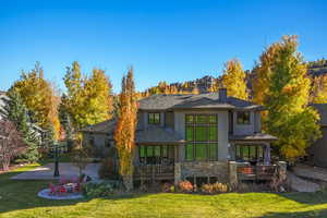 Rear view of house featuring a patio area and a yard